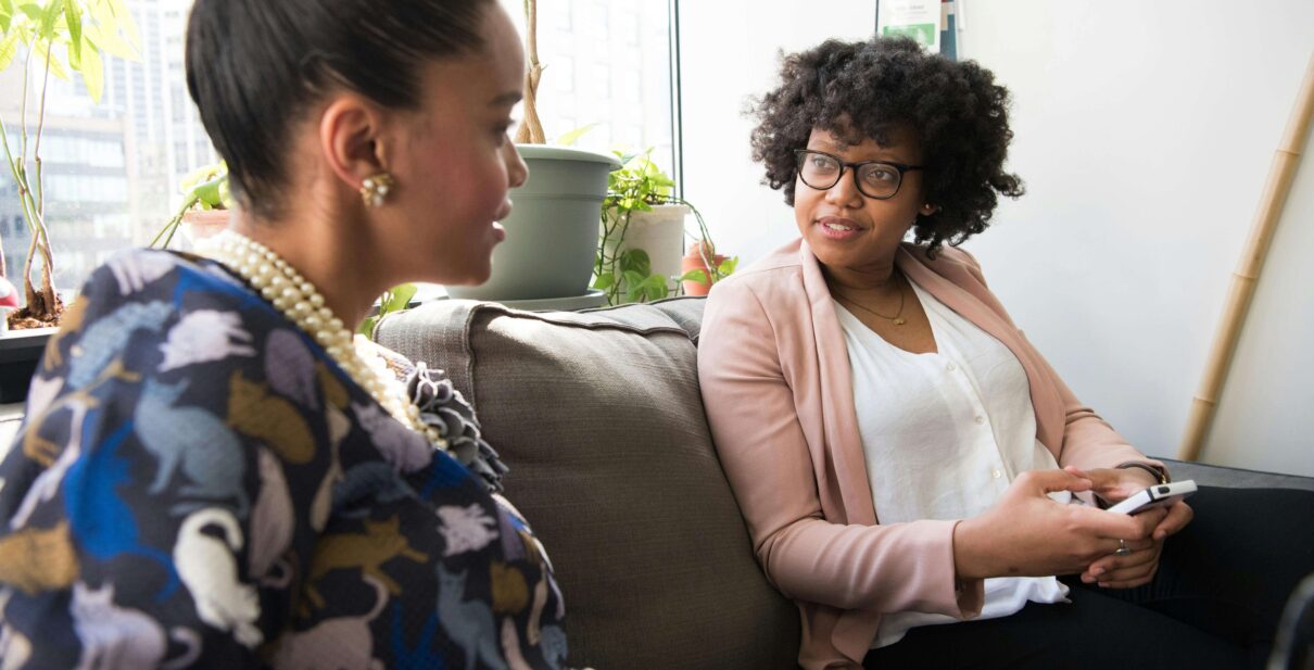 Two ladies discussing the difference between term & whole life insurance.