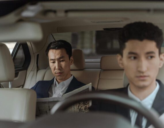 Wealthy Asian man riding back seat of a taxicab